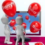 Sorry Balloons From Computer Showing Online Apology Or Remorse Stock Photo