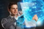 Business, Technology, Internet And Network Concept. Young Businessman Showing A Word In A Virtual Tablet Of The Future: Online Learning Stock Photo