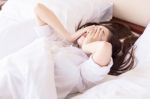 Young Woman Can Not Sleep. On Her Bed And Thinking Stock Photo