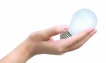 Light Bulb In Woman S Hand Stock Photo
