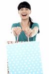 Cheerful Woman Holding Polka Dot Shopping Bags Stock Photo