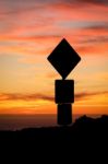 Road Sign Silhouette And Colorful Sunset Stock Photo