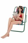 Bikini Woman Entertaining Herself Through Tablet Device Stock Photo