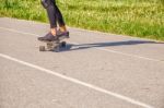 Young Woman Skateboarding In The Park Stock Photo