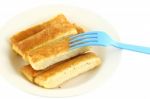 Bread Stick In White Disk With Blue Plastic Fork Stock Photo