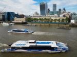 River Buses Cruising Along The River Thames Stock Photo