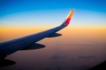 Aerial View Of Airplane Fly During The Sunset From Windows Plane Stock Photo