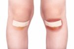 Child Knees With A Plaster (for Wounds) And Bruise Stock Photo
