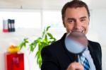 Business Executive Holding Magnifying Glass Stock Photo