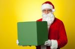 Santa Claus Delivering Big Green Gift Box Stock Photo