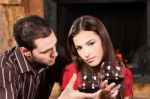 Couple Drinking Wine Near Fireplace Stock Photo