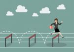 Business Woman Jumping Over Hurdle Stock Photo