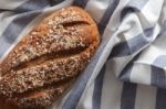 Dark Multigrain Bread Whole Grain Fresh Baked On Rustic Closeup Stock Photo