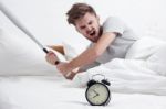 Angry Man Hand Holding Baseball Bat Smashing Alarm Clock Stock Photo