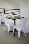 White Steel Chair And Wooden Table Stock Photo