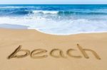 Word Beach On Sand Coast With Blue Sea Stock Photo