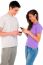 Teenage Couple Holding Smartphone