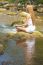 Beautiful Woman Practive Yoga On River In Nature