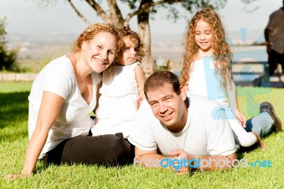 A Family Lying In Grass Stock Photo