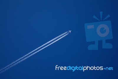 A Long Trail Of Jet Plane On Blue Sky Stock Photo