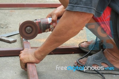 A Man Working With Grinder, Close Up On Tool Stock Photo