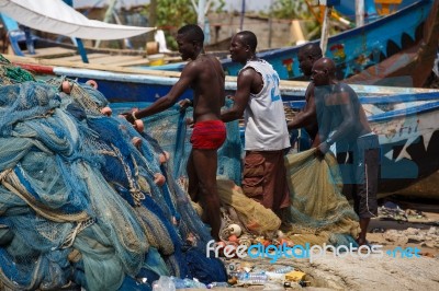 African Fisherman Woking In Hot Sunlight Stock Photo