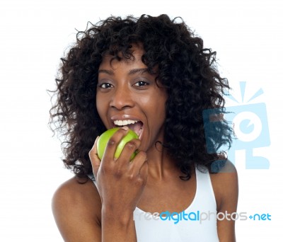 African Lady Eating Apple Stock Photo