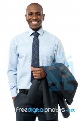 African Smiling Businessman, Hands In Pockets Stock Photo
