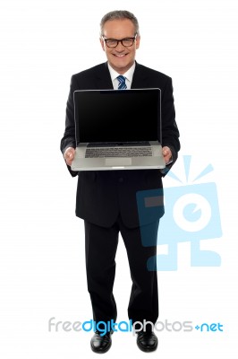 Aged Businessman Showing Newly Launched Laptop Stock Photo