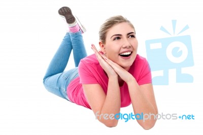 Amused Teenage Girl Lying On Flooor Stock Photo