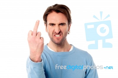 Angry Young Man Showing Middle Finger Stock Photo