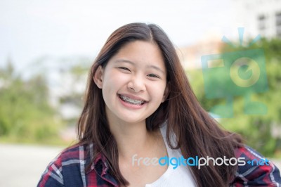 Asia Thai Teenager Women Scotch T-shirt Relax And Smile Stock Photo