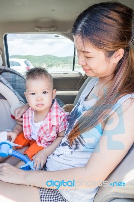 Asian Boy Sitting In The Car With His Mother Stock Photo