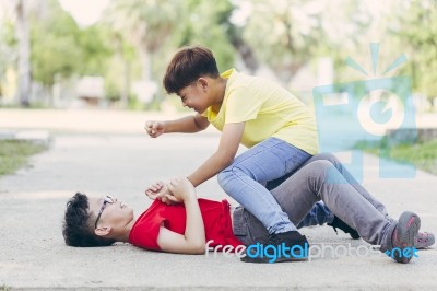Asian Boy Student Or Children Getting Bullied On Outdoor Stock Photo