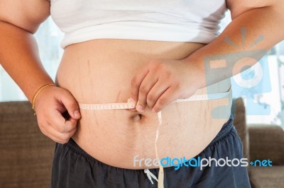Asian Fat Man Holding A Measuring Tape Stock Photo