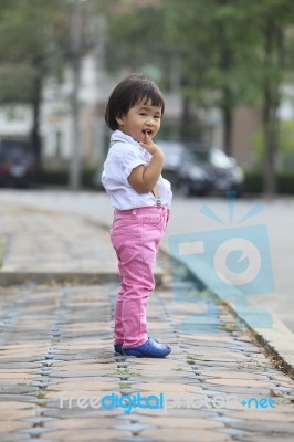 Asian Kid Children Standing Beside Street Road With Relaxing Emo… Stock Photo