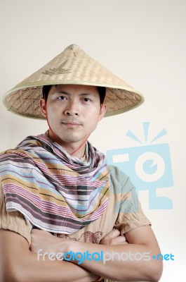 Asian Man Wearing Bamboo Hat Stock Photo