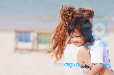 Asian Woman Holding Her Son Stock Photo