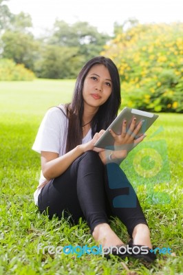 Asian Woman Using Tablet Computer Stock Photo