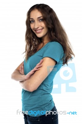 Attractive Female Standing Sideways And Smiling Stock Photo