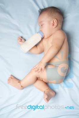 Baby Boy Holding Milk Bottle Stock Photo