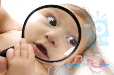 Baby Holding Magnified Glass Stock Photo