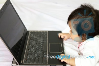 Baby Is Playing A Computer Stock Photo