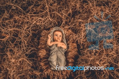 Baby Jesus Laying In A Manger Christmas Background Stock Photo