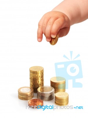 Baby's Hand And Coin Stock Photo