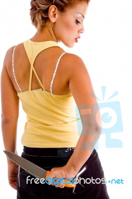 Back Pose Of Lady Holding Knife Stock Photo