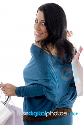 Back Pose Of Smiling Model With Carry Bags Stock Photo