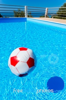 Beach Ball Floating On Water In Swimming Pool Stock Photo