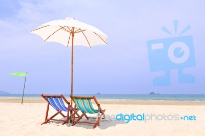 Beach Chairs And White Umbrella Stock Photo