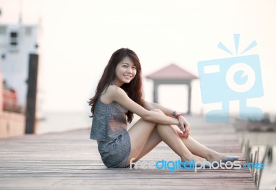 Beautiful Asian Woman Sitting On Wood Pier With Relaxing Emotion… Stock Photo